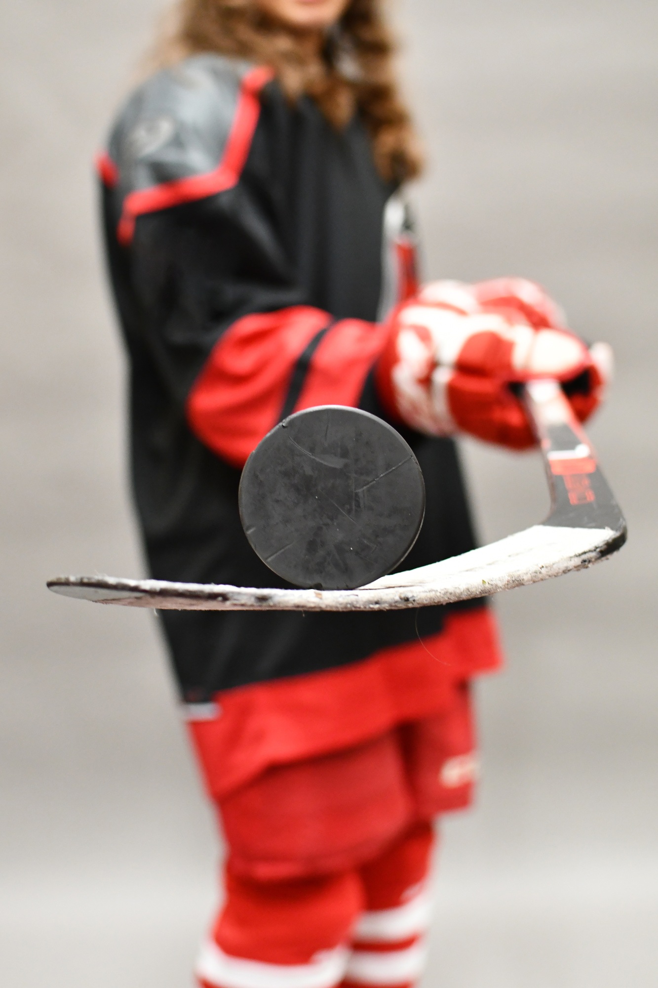 Ice Hockey Player balancing a puck on her stick