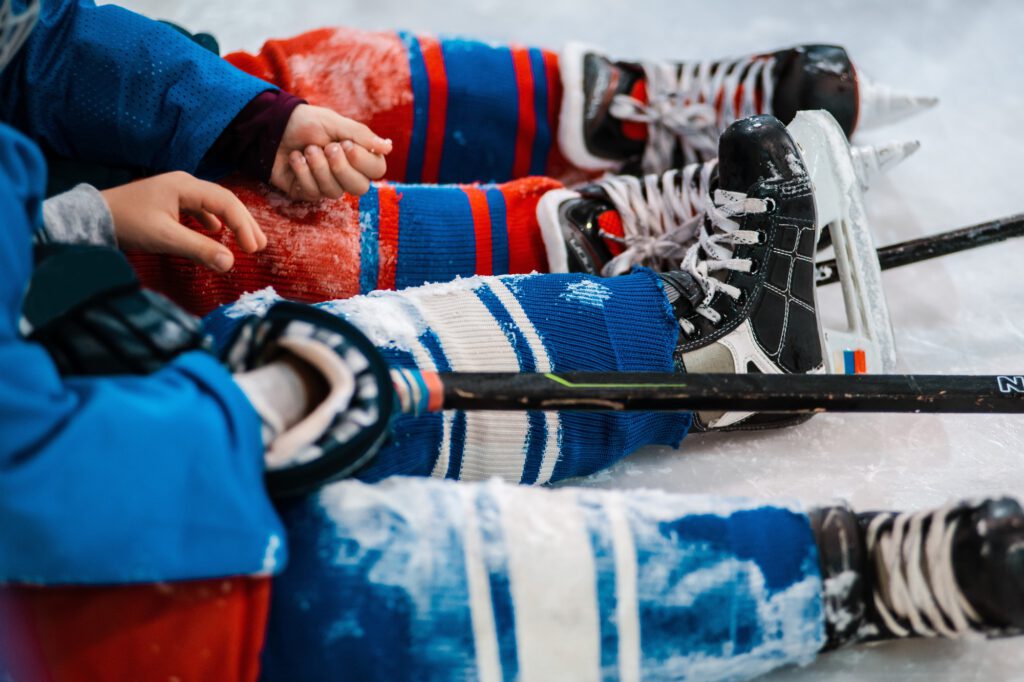 training sports children's hockey, close-up skates legs in ice skates.